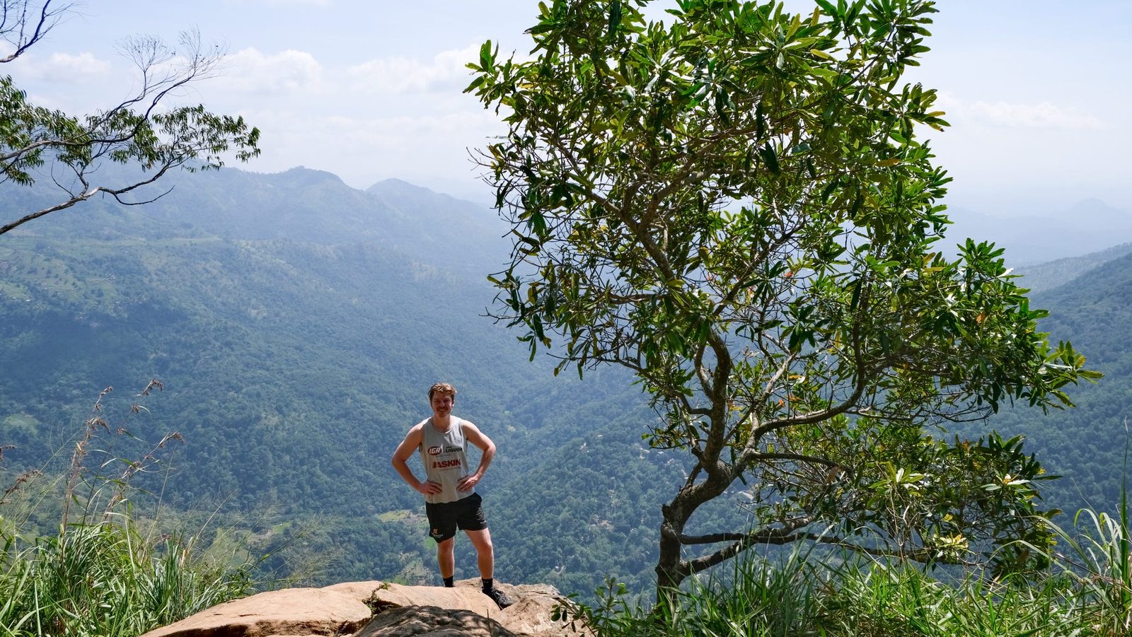 Max Miller standing at a mountain lookout on a hike